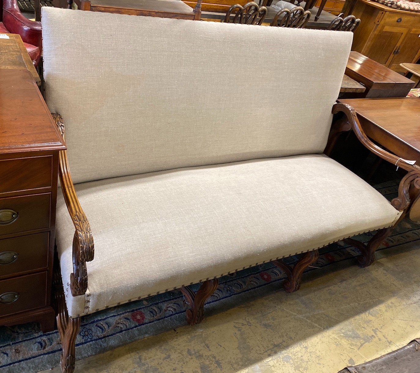 A Louis XVI style walnut settee recently upholstered in studded natural fabric, length 170cm, depth 74cm, height 116cm